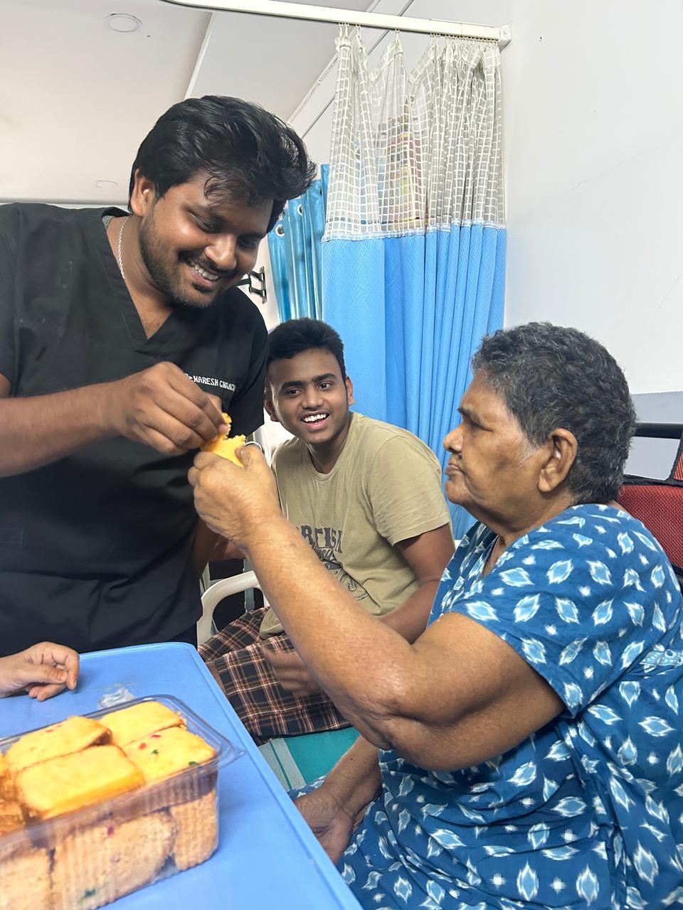 Dr. Naresh Chanchali celebrating with an elderly patient at her bedside
